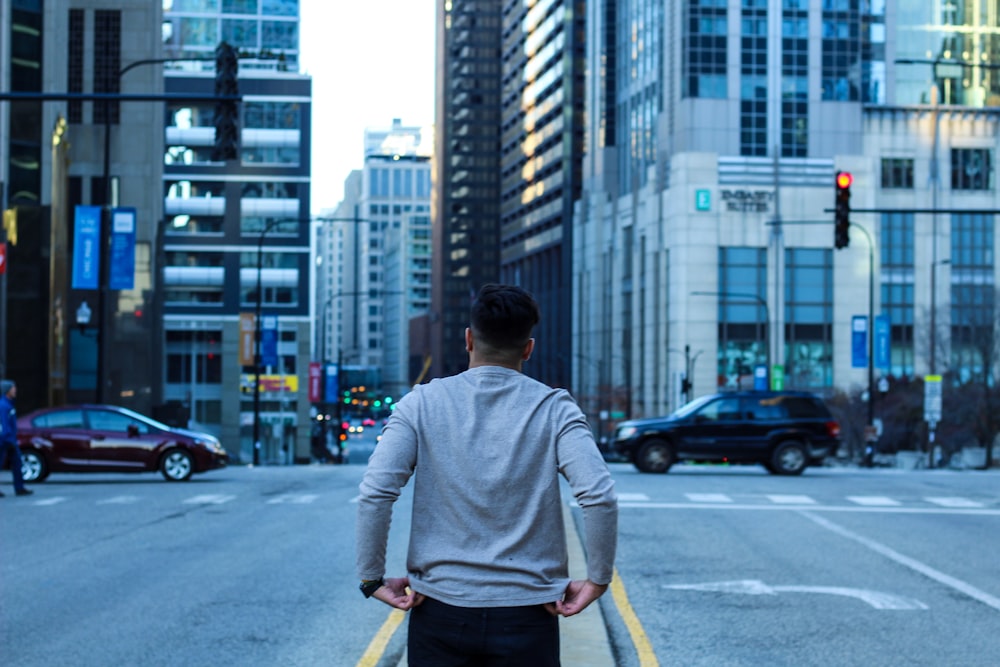 man walking in the middle of the street