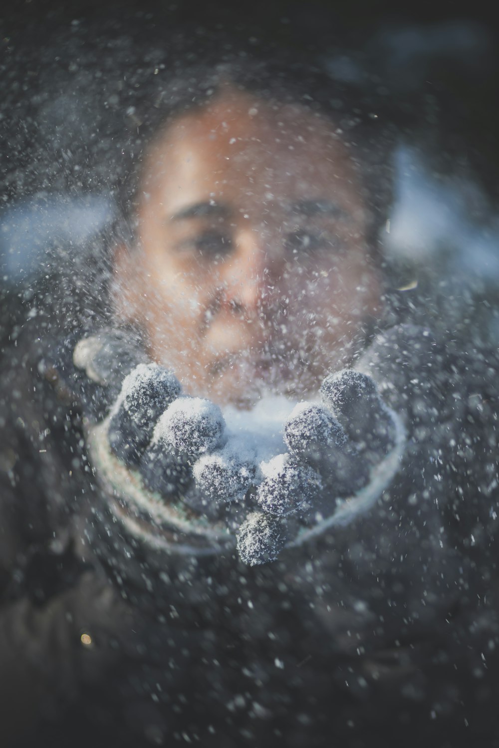 man blowing snow in time-lapse photography