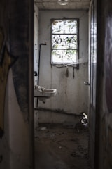brown wooden door near white ceramic sink