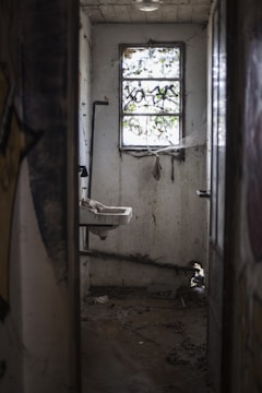 brown wooden door near white ceramic sink
