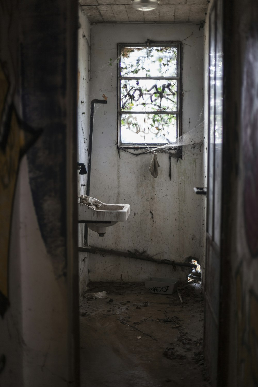 brown wooden door near white ceramic sink