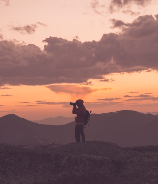 silhouette of man standing on top of mountain during sunset in Colorado United States