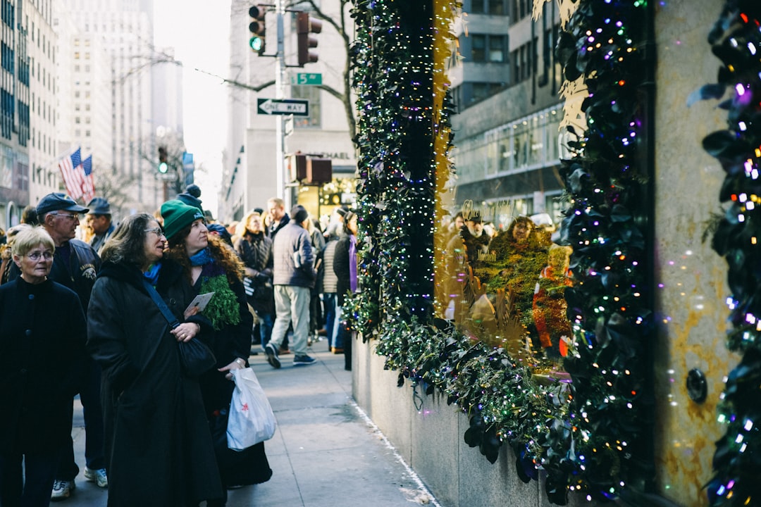 people in sidewalk staring at string lights, It was the week before Christmas and everyone was out finishing their shopp