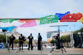 band playing on stage during daytime