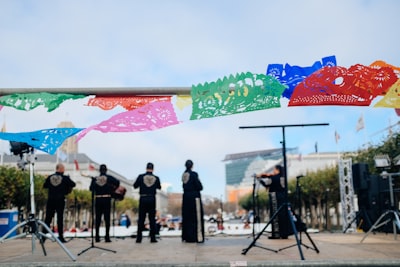 band playing on stage during daytime mariachi teams background