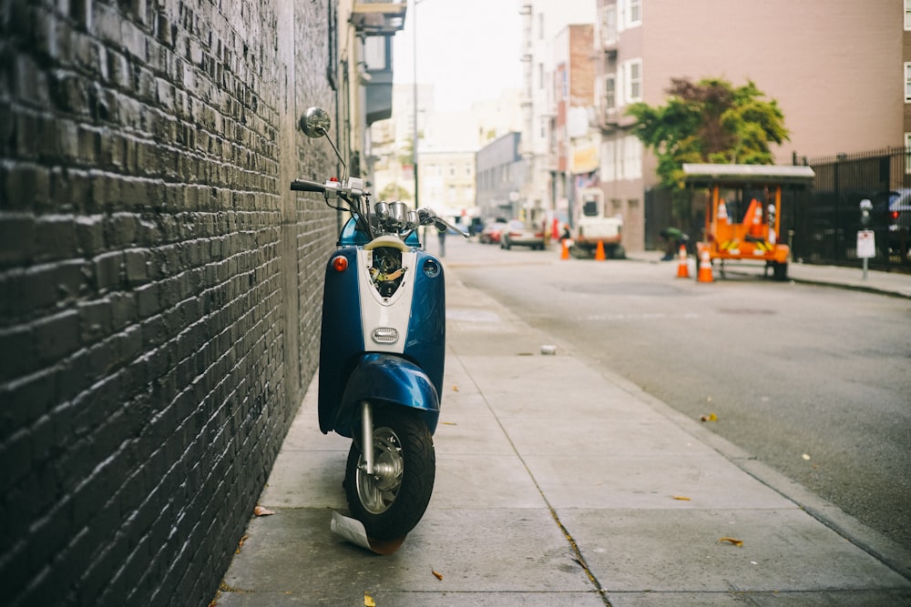 white and blue motor scooter
