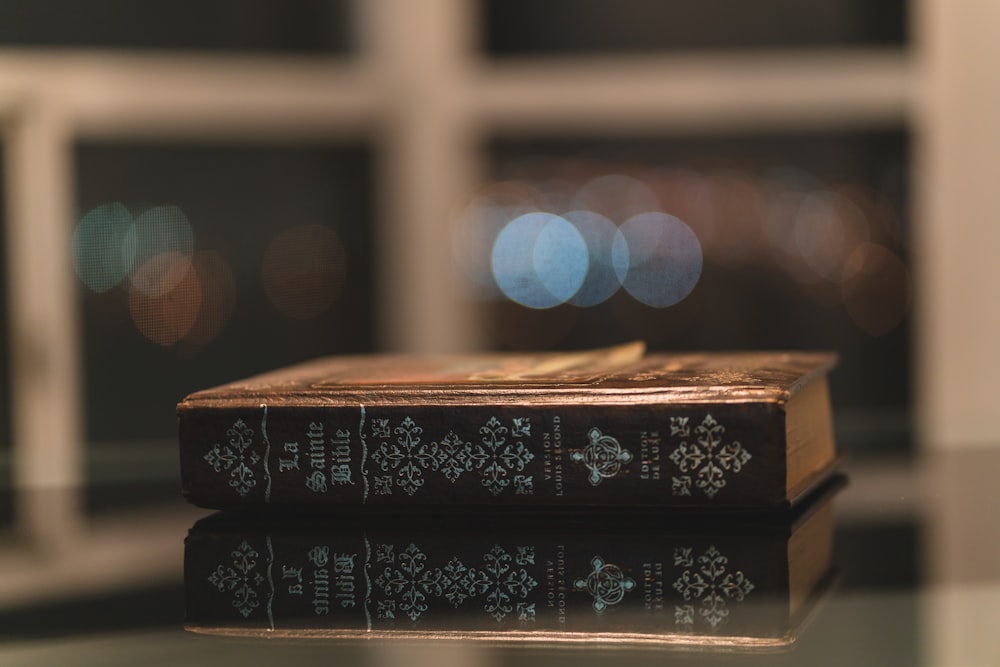 selective focus photography of brown hardbound book