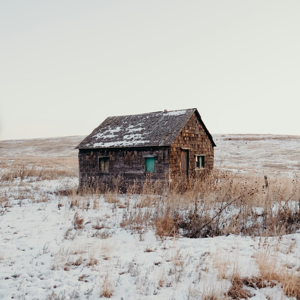 house in the middle of grass fields