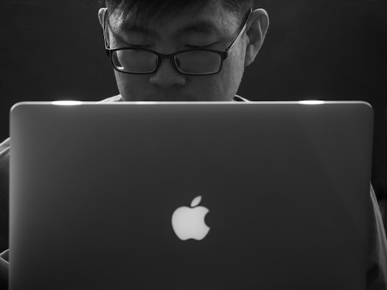 A person happily using a laptop with the FocusFlow extension active, highlighting text in OpenDyslexic font.