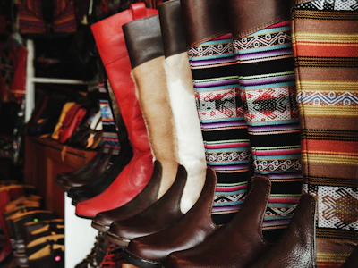 Kids’ colorful western boots lined up, showing playful patterns and bright Mexican green and red accents.
