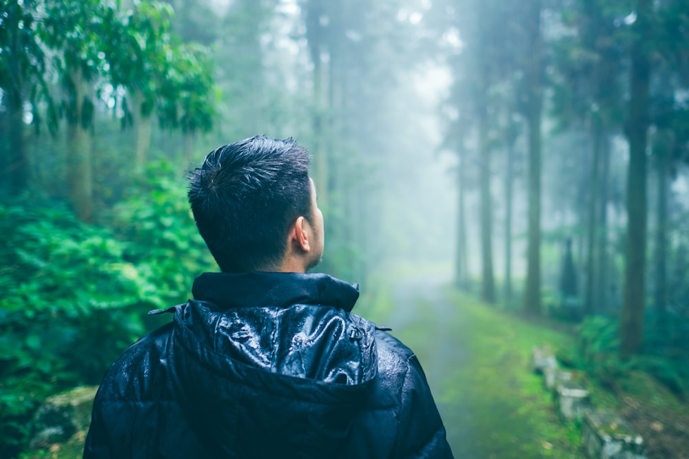 man walking on forest trail looking ahead