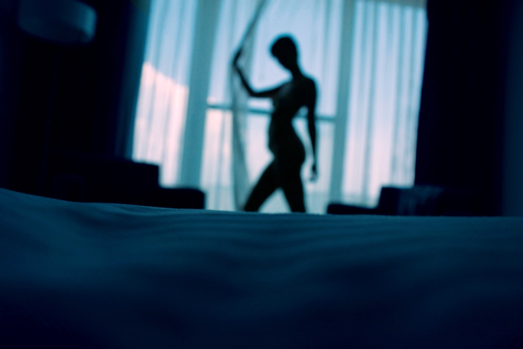 sillouehtte photo of woman standing beside window curtains, Self Portrait