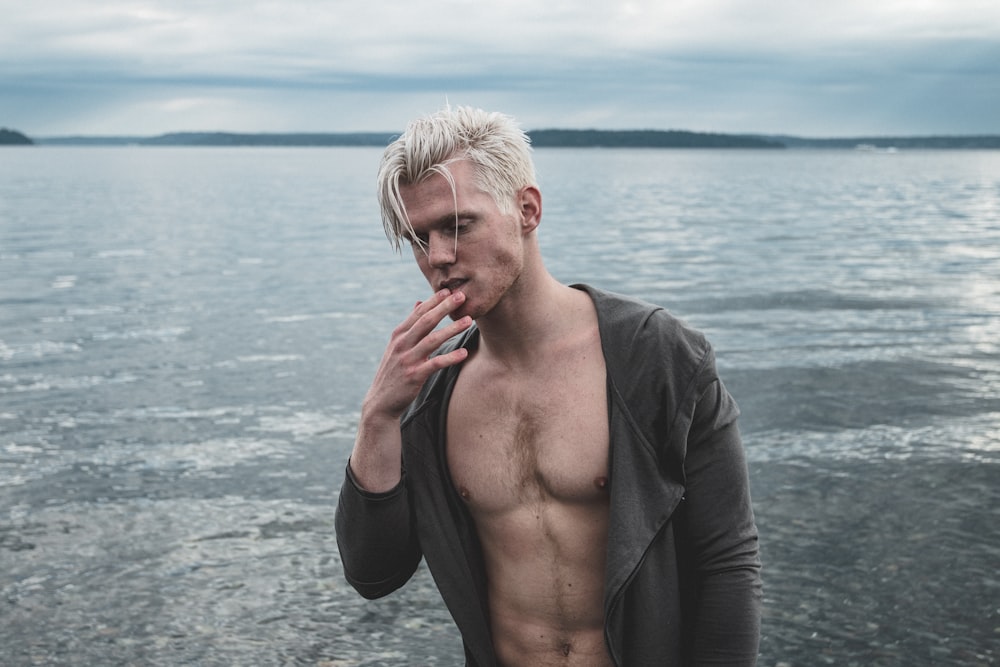 man wearing black top near body of water