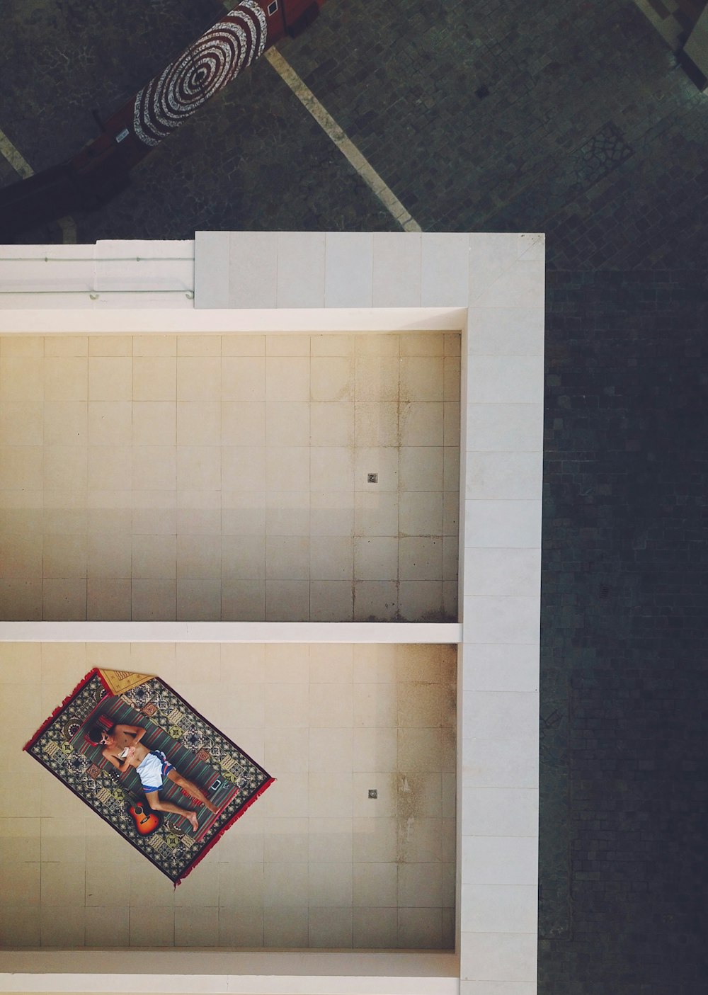 bird's eye view of person resting on rug