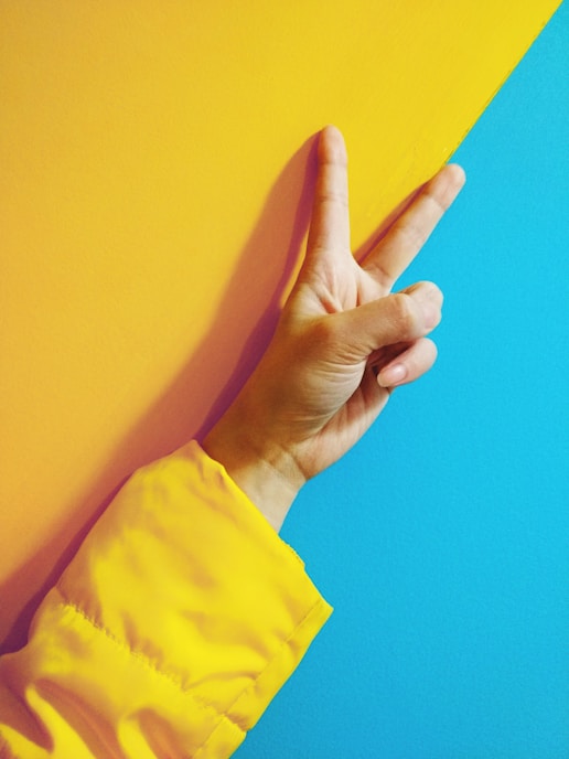 person doing peace hand sign