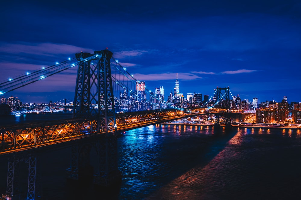 suspension bridge under clear sky during nighttime