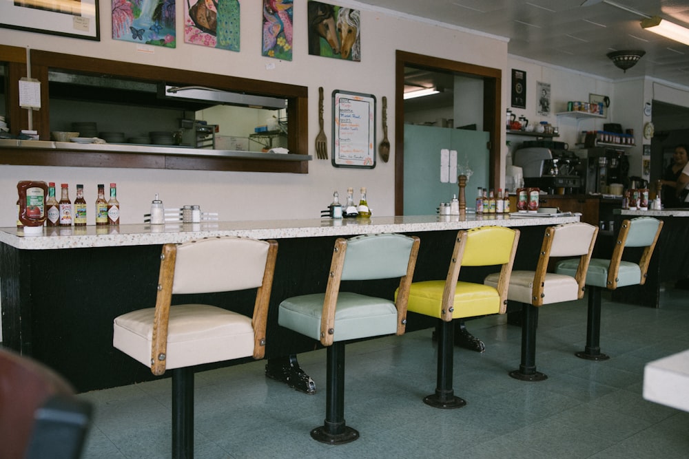 assorted-color barstools in front of table