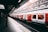 white and red train beside building at daytime