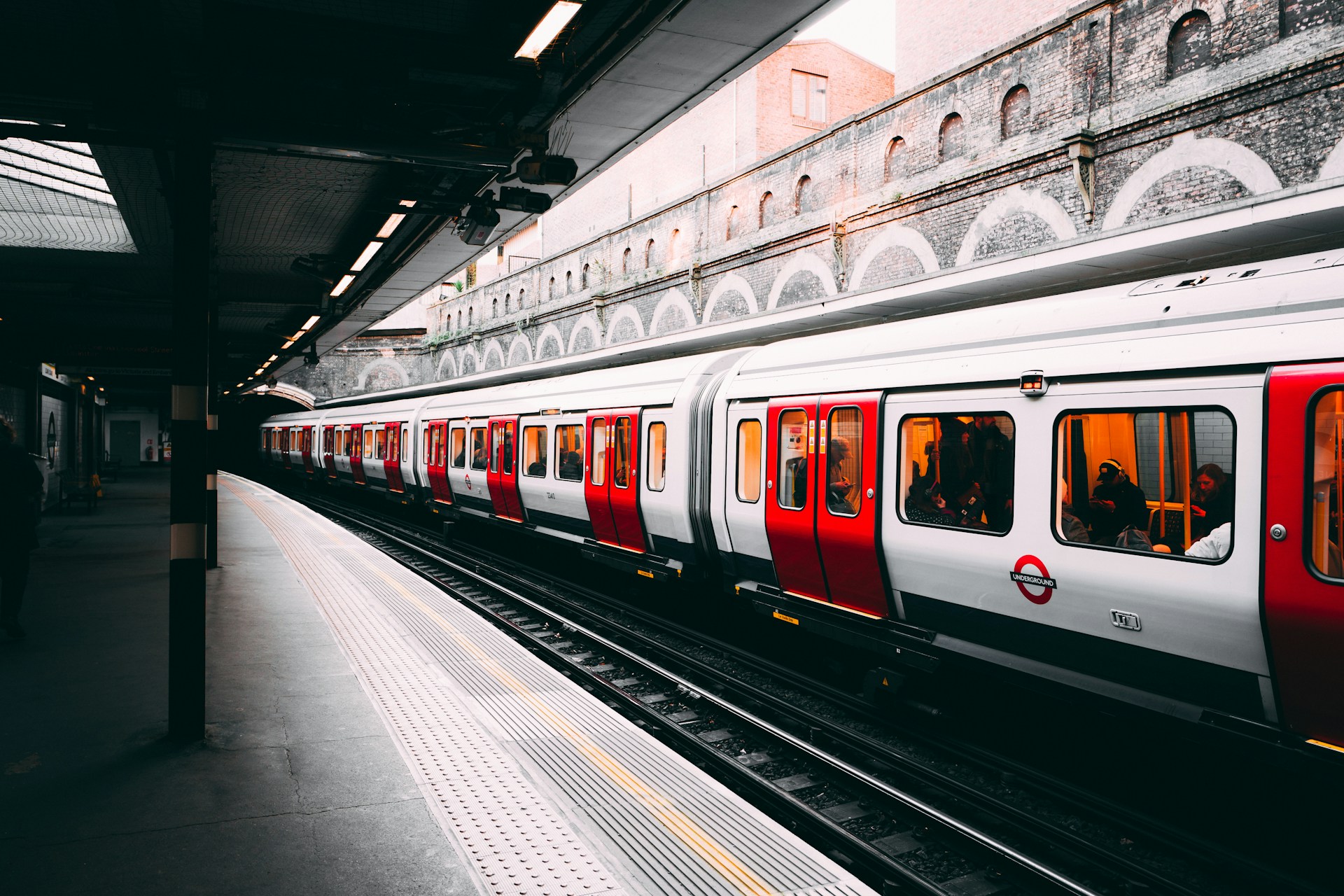 white and red train beside building at daytime