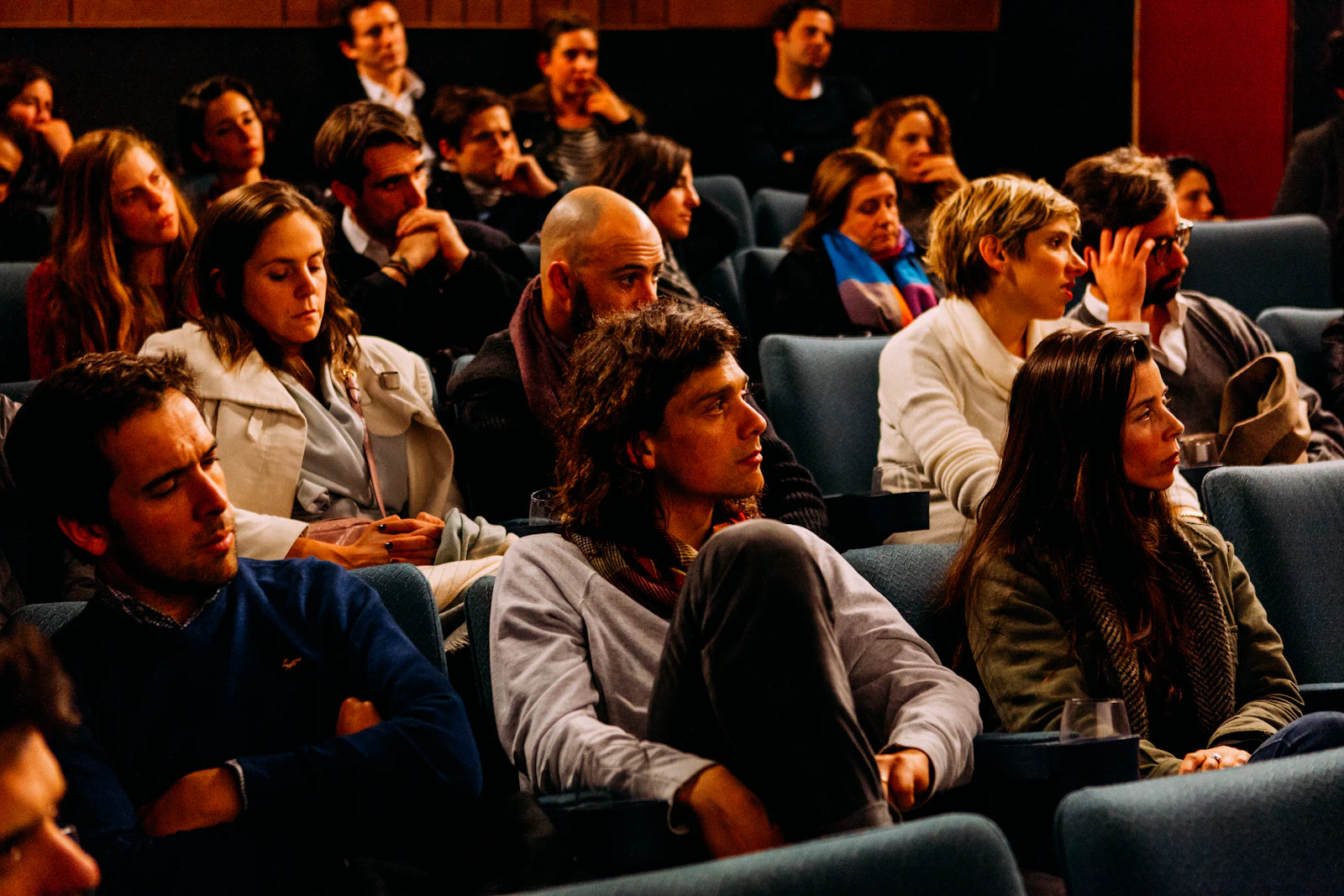 An audience seated and waiting in an event room