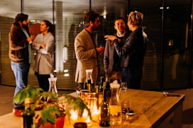 five person standing while talking each other