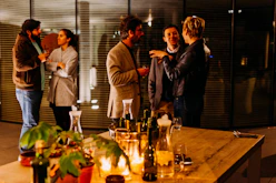 five person standing while talking each other
