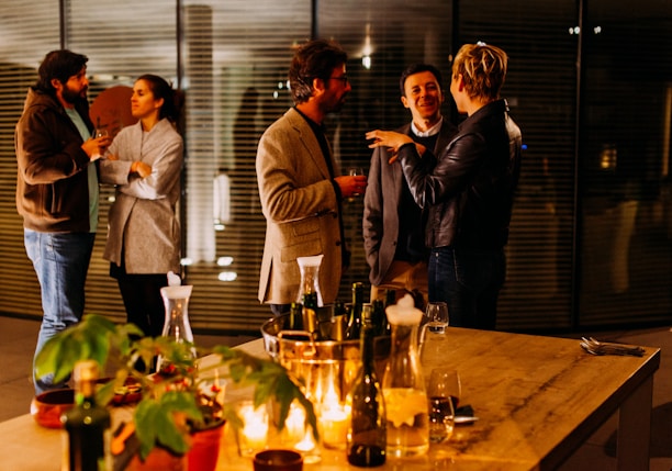 five person standing while talking each other