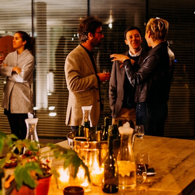 five person standing while talking each other