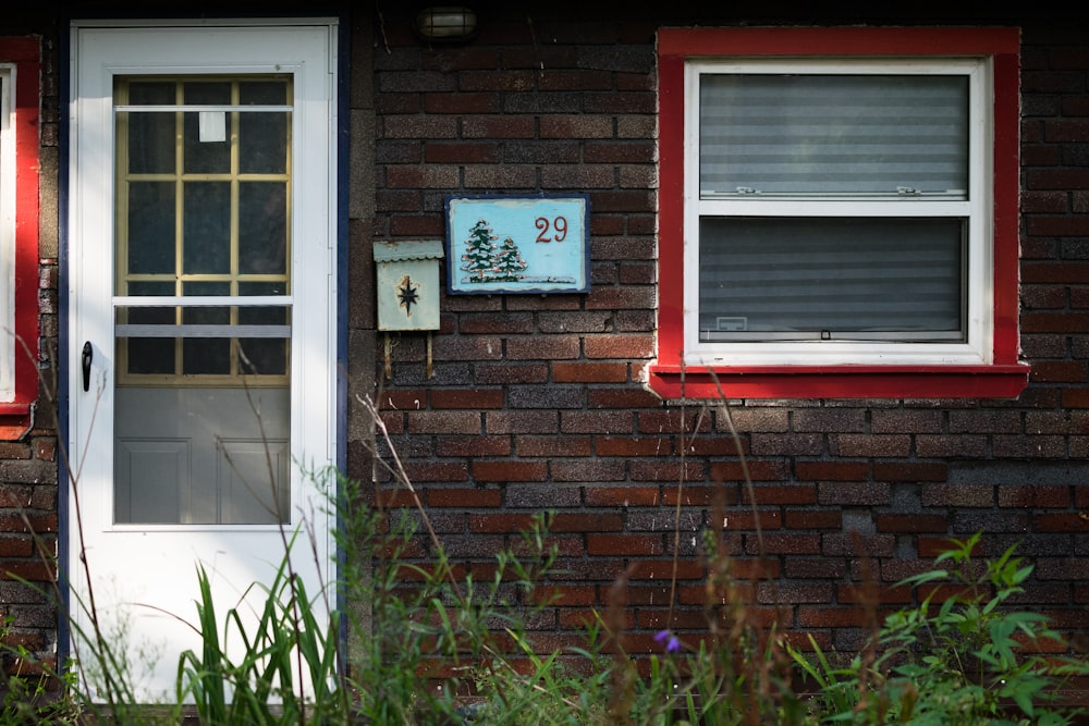 closed white wooden door beside plants