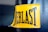 A close-up view of a yellow rectangular label with black stitching that has the word 'EVERLAST' printed in bold black capital letters. The label is attached to a dark-colored textured material, which appears to be part of a punching bag or similar sporting equipment.