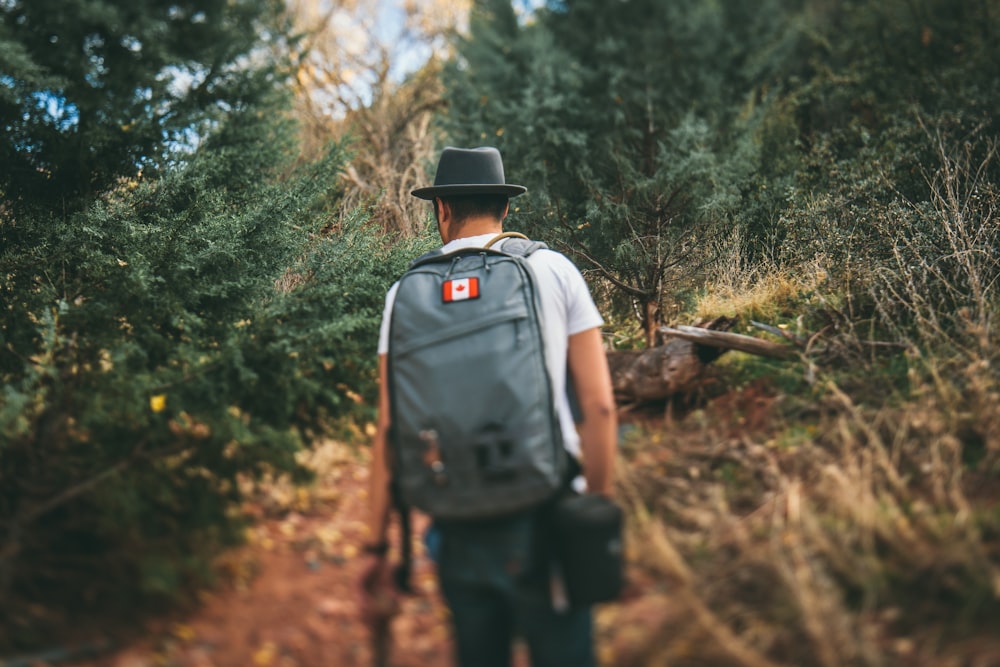 man carrying gray backpack