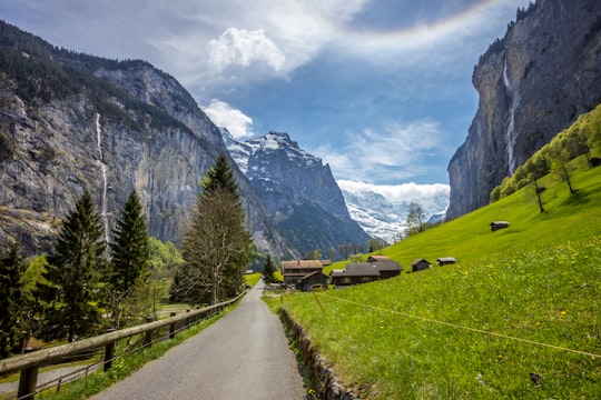 road near green hill during daytime in Lauterbrunnen Switzerland