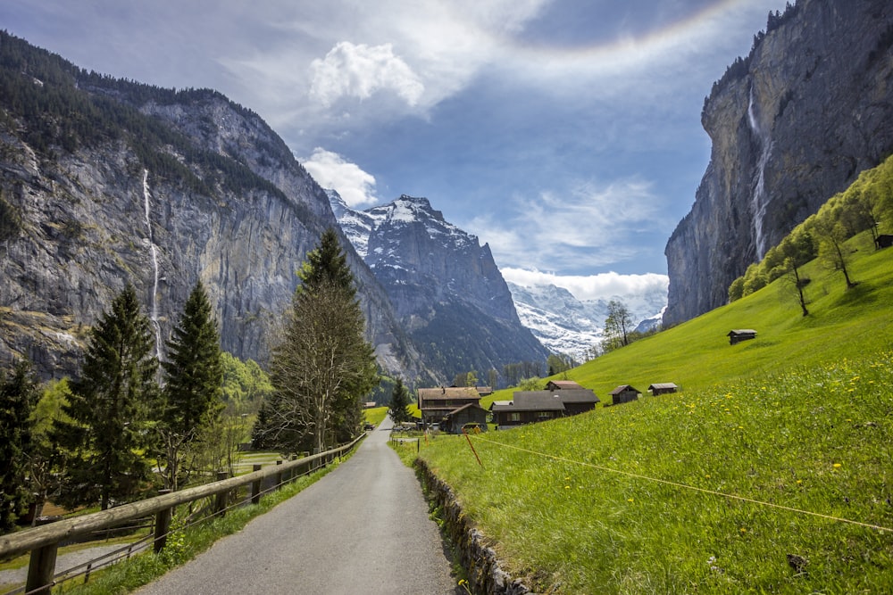 road near green hill during daytime