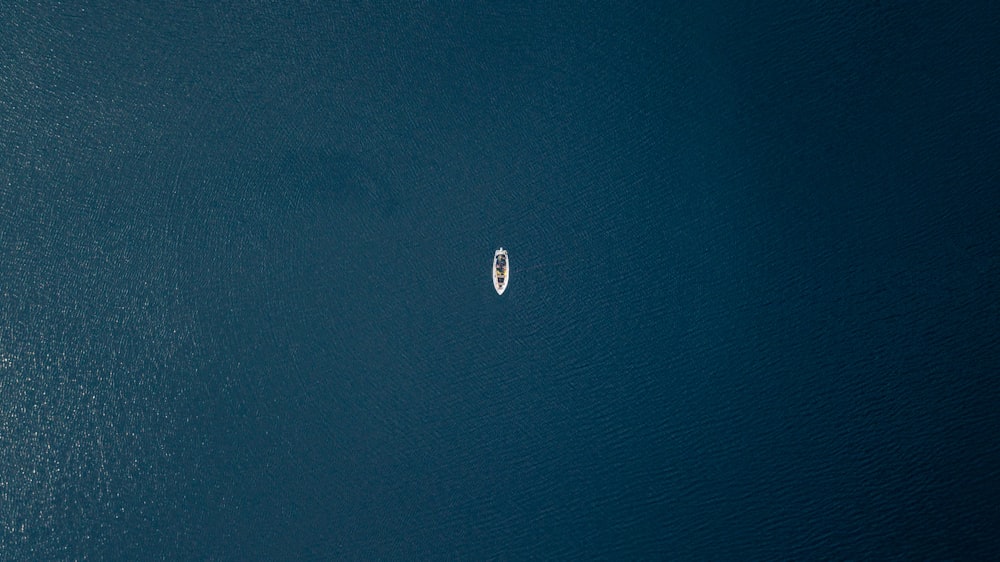 an aerial view of a boat in the water