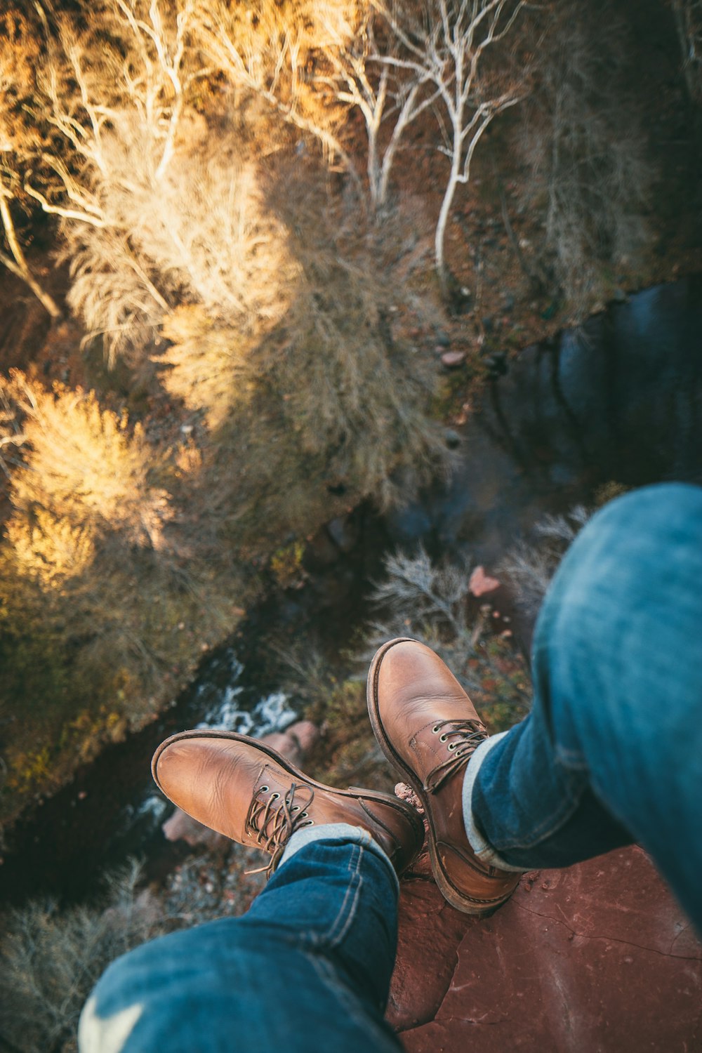 person standing on rock cliff