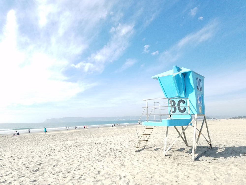 blue lifeguard house near beach shore