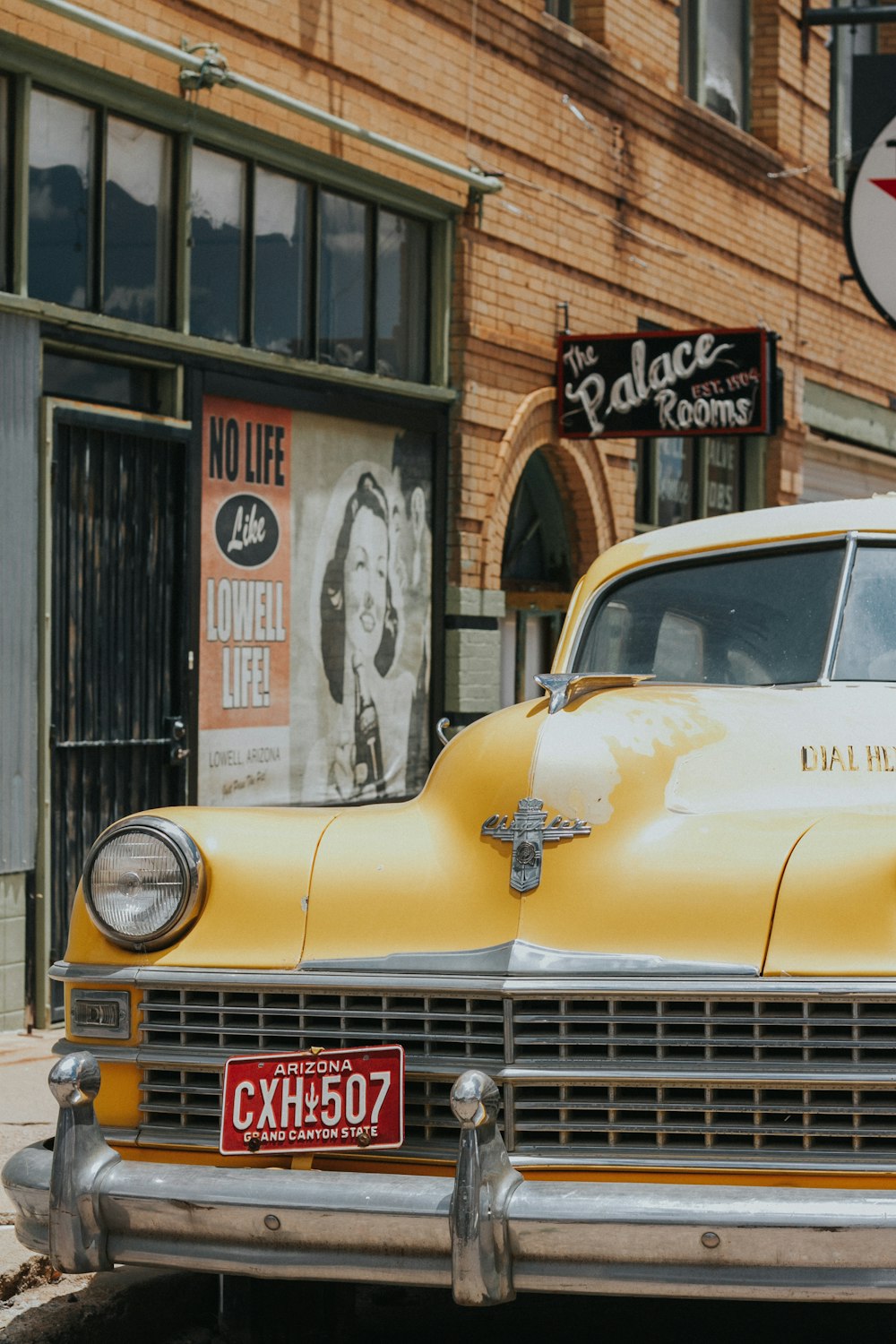 yellow vehicle parked next to building