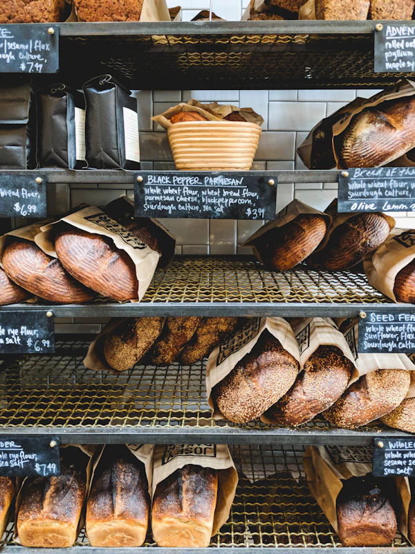 Freshly baked sourdough loaves cooling on a wooden rack