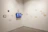 A minimalist gallery wall featuring varied image sizes and a sleek embedded video screen.