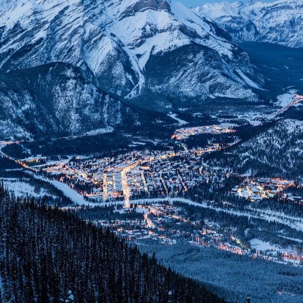 village under snow capped mountain