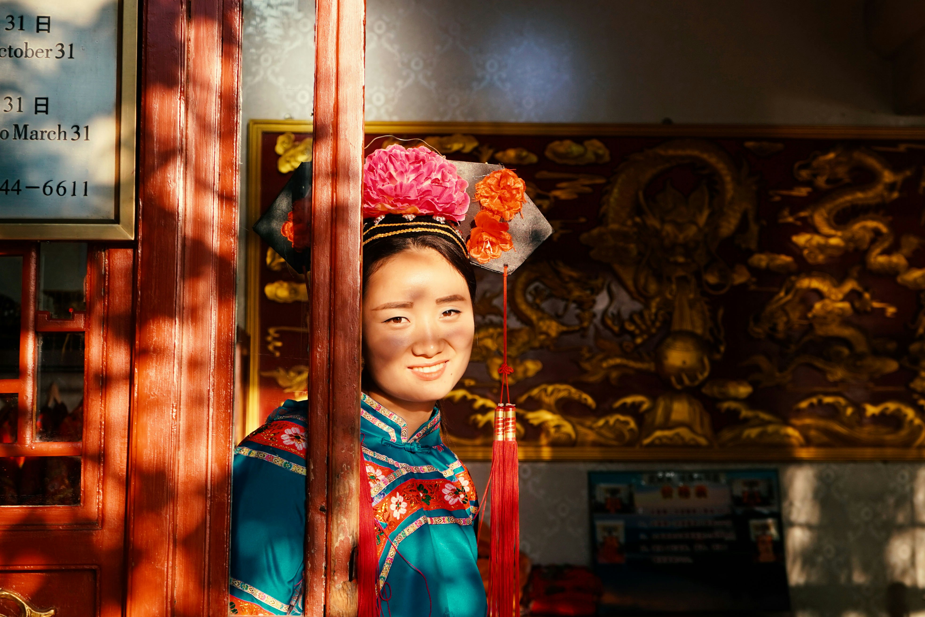 woman leaning on brown wooden wall at daytime