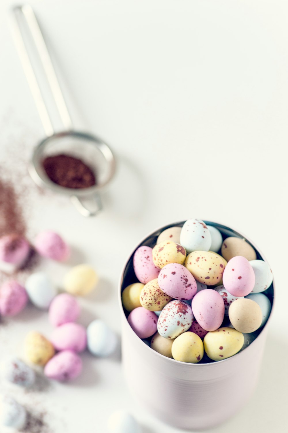 assorted-color quail eggs on can