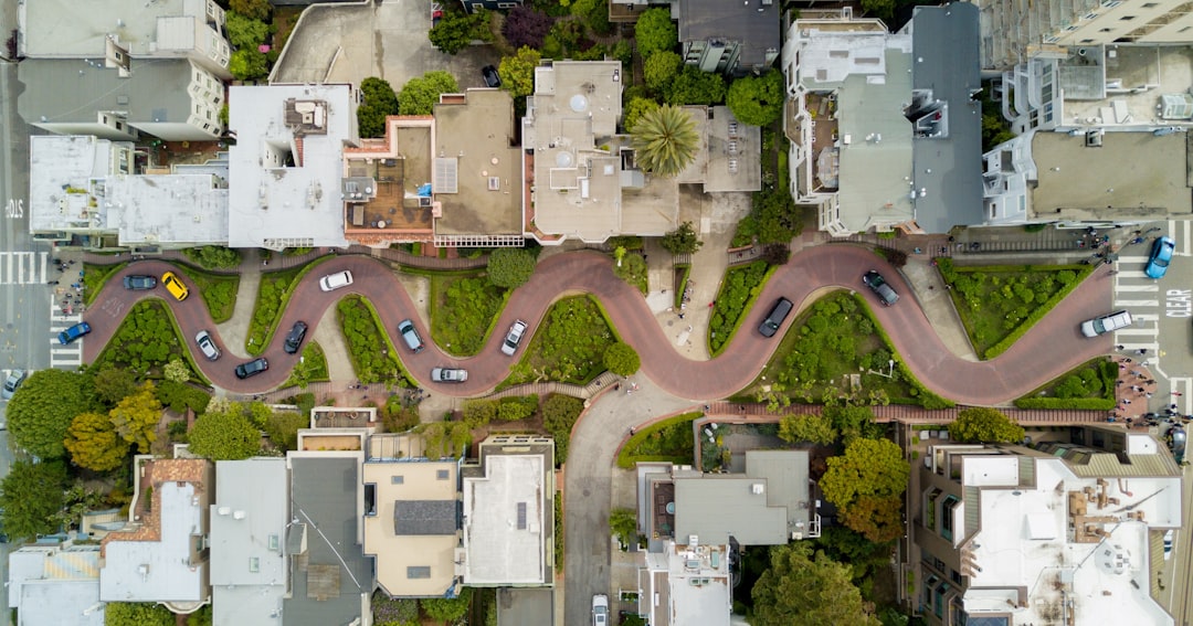 aerial photography of gray concrete houses and brown road