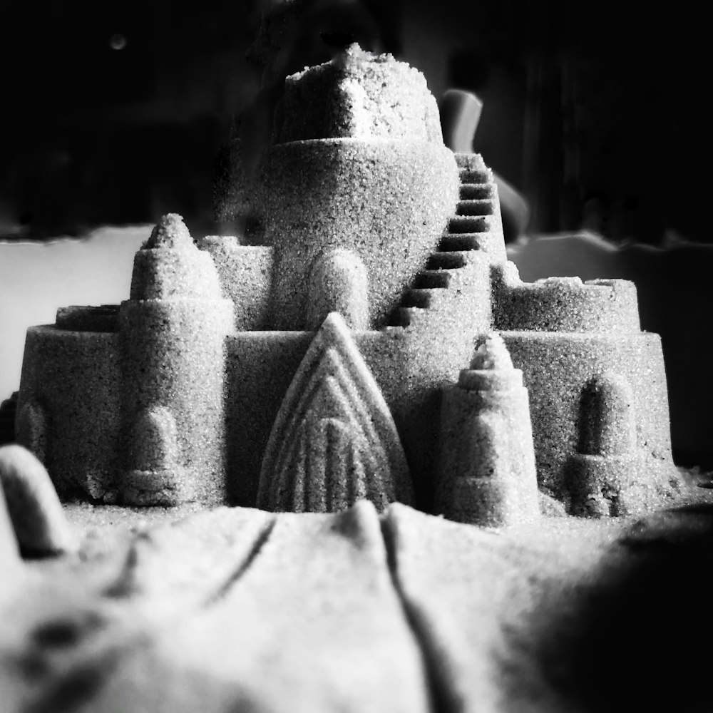 grayscale photo of sand castle
