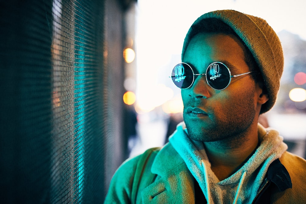man wearing sunglasses looking at window