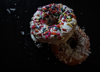 two doughnuts topped with sprinkles