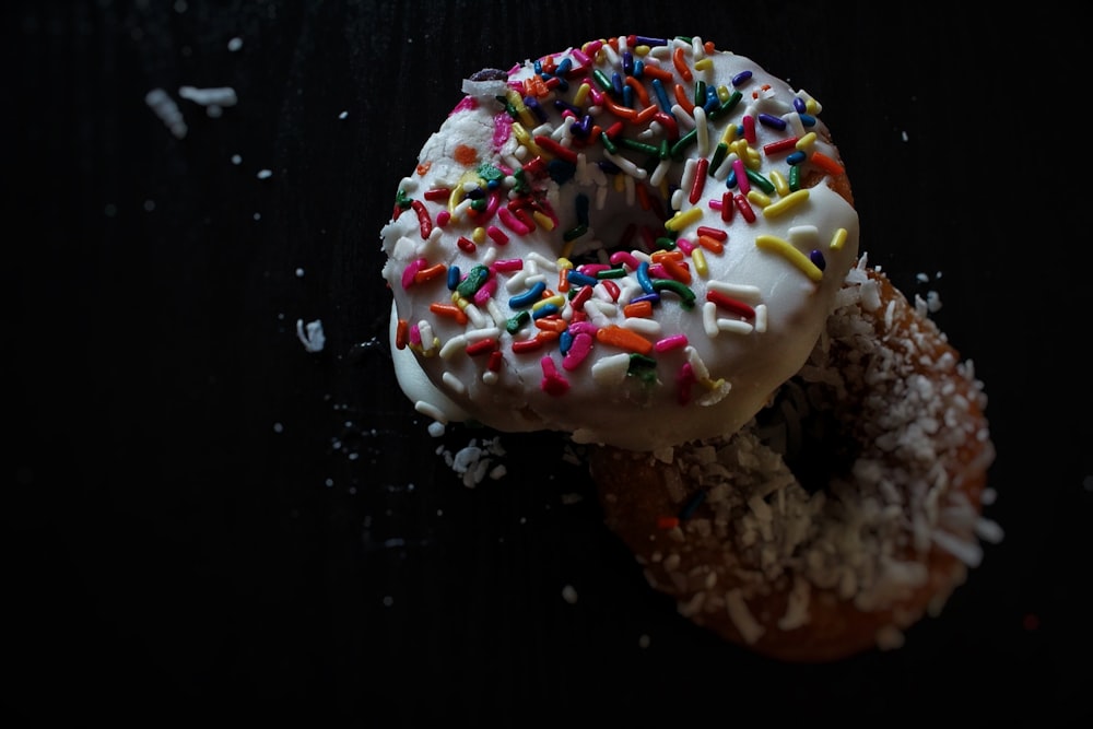 two doughnuts topped with sprinkles