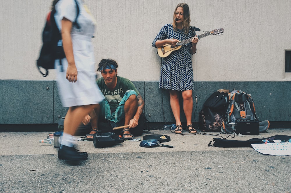 woman playing guitar on street