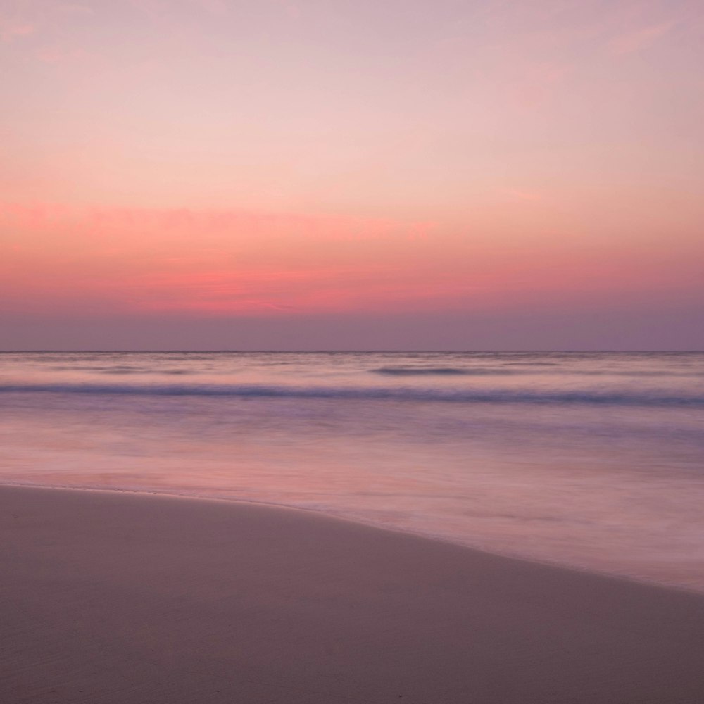 waves rushed to shore at sunset