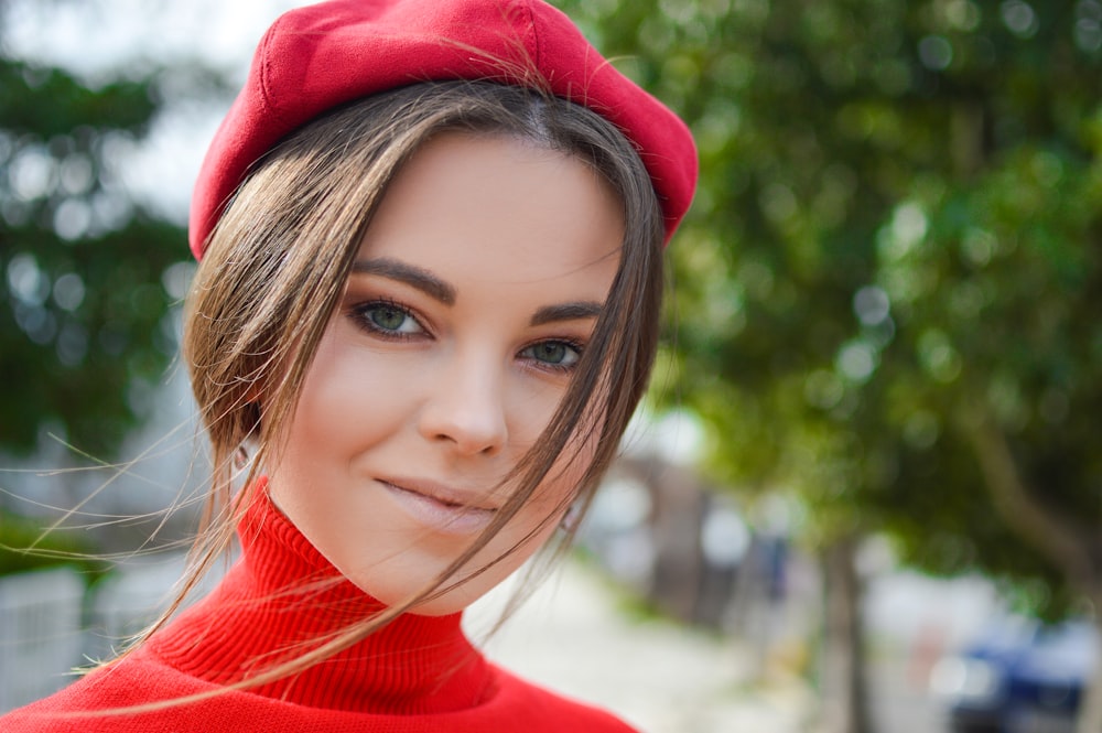 closeup photo of woman wearing red cap